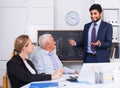 Manager male is reading financial report to colleagues on meeting Royalty Free Stock Photo