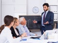 Manager male is reading financial report to colleagues on meeting Royalty Free Stock Photo