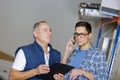 Manager and man calling on phone at workshop warehouse Royalty Free Stock Photo