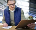 Manager man, glasses and clipboard in logistics warehouse for inspection or inventory checkup. Male supervisor, writing Royalty Free Stock Photo