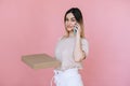 Manager with a phone in his hands looks at the camera and pizza boxes on an  pink background Royalty Free Stock Photo