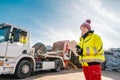 Manager registering truck unloading biomass in compost works