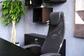 Manager's office setting. A black armchair next to a black desk. Royalty Free Stock Photo