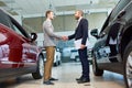 Manager Selling Cars in Showroom Royalty Free Stock Photo