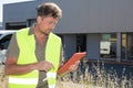 manager showing tablet pc front large warehouse