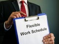 A manager shows flexible work schedule in clipboard.