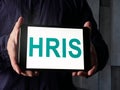 Manager shows HRIS human resource information system on the tablet. Royalty Free Stock Photo