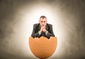 Man sitting into a egg Royalty Free Stock Photo
