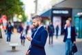 Manager with smartphone listening music outside in the street Royalty Free Stock Photo