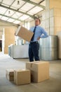 Manager suffering from back pain while holding heavy box