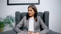 Manager in suit smiling during video chat in office. Royalty Free Stock Photo