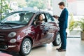 Manager talking with a smiling customer after test-driving a Royalty Free Stock Photo