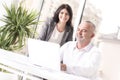 Manager teaching his young secretary some work inside an office Royalty Free Stock Photo