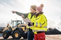 Manager and worker in biomass compost works engaged in discussion