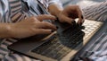 Manager working laptop overtime in pajamas closeup. Girl hands typing keyboard