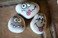 managing emotions emoji faces on stones - sad, happy, surprised worried and angry feelings draw .