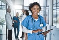 Managing her doctoring duties with digital tech. Portrait of a young doctor using a digital tablet in a hospital with