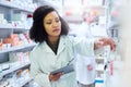 Managing a modern pharmacy demands modern technology. a young woman using a digital tablet to do inventory in a pharmacy Royalty Free Stock Photo