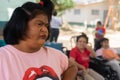 Managua, Nicaragua, March 21th 2022: An adult latin woman with Down syndrome observes the activities