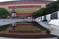Manahan Stadium facade reflected on water puddle (Surakarta, Indonesia-Nov 26, 2022)