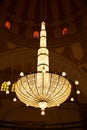 MANAMA, BAHRAIN - JUNE 26: A beautiful massive intricate chandelier hanging in the middle of the dome of Al Fateh Grand Mosque on