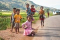 Manandoana, Madagascar - April 26, 2019: Group of unknown Malagasy kids playing on road next to rice field, small hills in Royalty Free Stock Photo