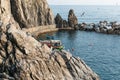 Sheer rock face and seawall or breakwater making small boat harbour at Manarola on Cinque Terre