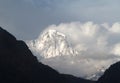 Manaslu mountain with snowy peaks in clouds on sunny bright day in Nepal Royalty Free Stock Photo