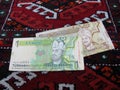 1 and 5 manats banknotes a Turkmen rug Royalty Free Stock Photo