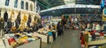 10.11.2022 Manavgat, Turkey - Bazaar. Panoramic indoor shot of many clothing stalls at Turkish marketplace. Various