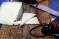 Cured cheese cut on a wooden board. A traditional management of my village