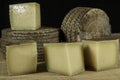 Manchego Curado cheeses, one of them cutted into pieces