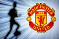MANCHESTER, ENGLAND, JULY. 1. 2019: Manchester United Football club logo, Premier League, England. Soccer player silhouette Royalty Free Stock Photo