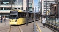 Metrolink Tram at St Peters Square Station.  Public Transport Vehicle.  People in shot Royalty Free Stock Photo