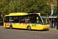 Yellow Transport for Greater Manchester bus waiting at a bus stop for passengers