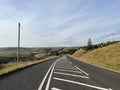 Manchester Road, with moorland, and an old stone house in, Marsden, Yorkshire, UK Royalty Free Stock Photo