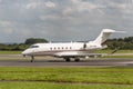 MANCHESTER UK, AUGUST 20 2020: NetJets Europe Bombardier Challenger 350 is documented taxying on the airport taxiways after Royalty Free Stock Photo