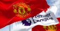 Manchester United Football Club and Premier League flags waving on a clear day