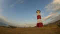 Tourists watching the sunset from the lookout of the lighthouse with a blue sky with clouds in the background Royalty Free Stock Photo
