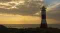 View of Mancora lighthouse over the mountain on a cloudy sunset