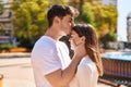 Mand and woman couple hugging each other and kissing at park Royalty Free Stock Photo