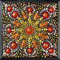 Mandala dot art painting on wood tiles. Beautiful mandala hand painted by colorful dots on black wood. National patterns Royalty Free Stock Photo