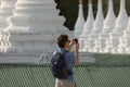 A Western tourist takes pictures in Sanda Muni Pagoda, Mandalay Royalty Free Stock Photo