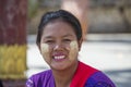 Happy young Myanmar girl with thanaka on her smile face on street market in Mandalay, Myanmar