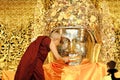 MANDALAY, MYANMAR - FEBRUARY 3,2018 : The senior monk being of face wash to Mahamuni Buddha image at Mahamuni temple is Buddha and