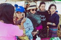 MANDALAY-Myanmar, January 20, 2019 : Female tourist guide paints tanaka powder on female tourist face while traveling on boat on