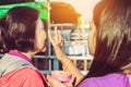 MANDALAY-Myanmar, January 20, 2019 : Female tourist guide paints tanaka powder on female tourist face while traveling on boat on