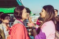 MANDALAY-Myanmar, January 20, 2019 : Female tourist guide paints tanaka powder on female tourist face while traveling on boat on