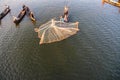 Mandalay, Myanmar - Nov 12, 2019: Fishermen near U Bein bridge in Amarapura