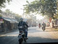 Mandalay Myanmar - Rural road crowded with motorcycles and trucks in the morning.